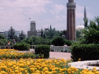 Yivli Minaret and Clock Tower are behind of flowers