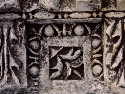 A detail view: carved figure at stone
