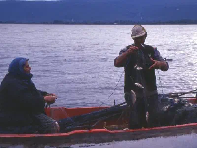 Most villagers earn their living as fisherman. Woman and man fish together early in the morning.