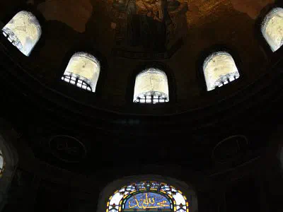 Stained glasses and Virgin Maria with Jesus Christ figure on ceiling