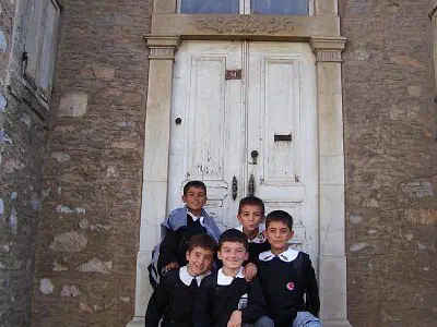 School children front of a old stone house in Muğla. They are very curious for their pictures to be taken.