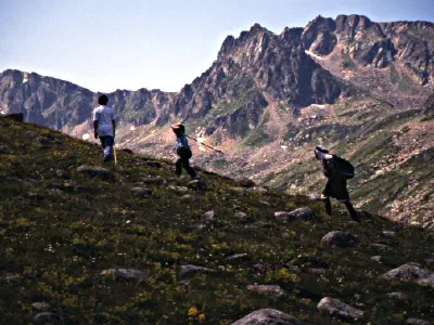 An old woman walking on the mountain path with her grandchilds. They had have much more energy than us :).